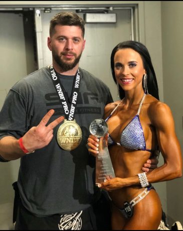 Shauna Koehler, 2-time WNBF Overall Bikini World Champion, with her Natural Bodybuilding Coach Ryan Sullivan of Team SUF, exemplifying excellence in natural bodybuilding.